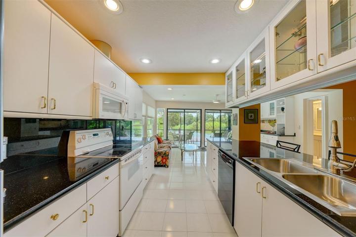 Galley-style kitchen looking through to sunroom and gorgeous lake views.