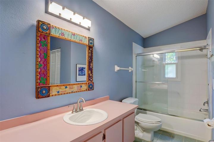 The bathroom offers a combination tub/shower and opens to the second bedroom.