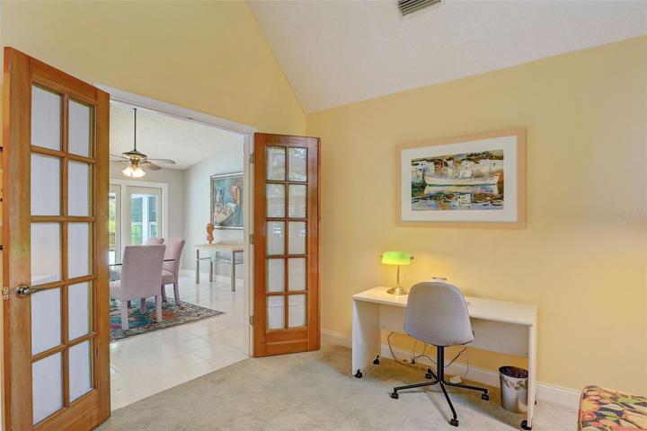 The second bedroom is complete with Frenchdoors, vaulted ceiling, large arched window overlooking the front yard, and would function well as a nursery or office
