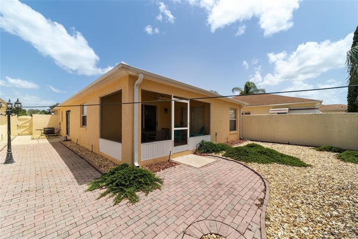 Rear angle, shows the paved patio & walk way along the side