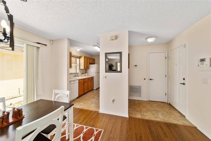 Dining & kitchen view with the front door to the right corner