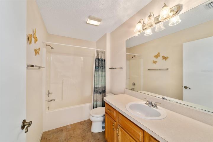 Hall/ guest bathroom has shower tub combo & ceramic tile
