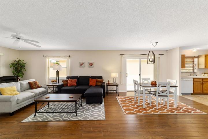 Living room has slider doors that lead to rear screened Lanai
