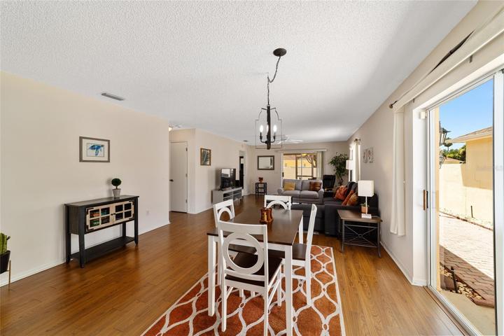 Dining has glass slider doors that lead to the side yard with open patio to BBQ.