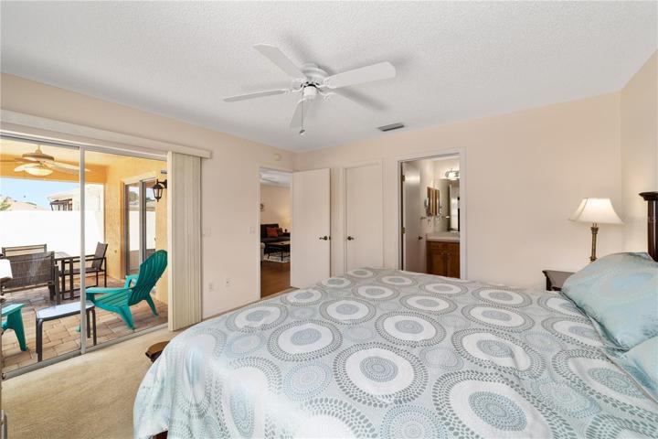 Primary bedroom Glass slider doors also lead to the rear screened Lanai