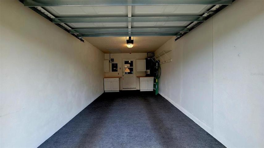 Carpeted garage w/door to kitchen. Electric door opener.