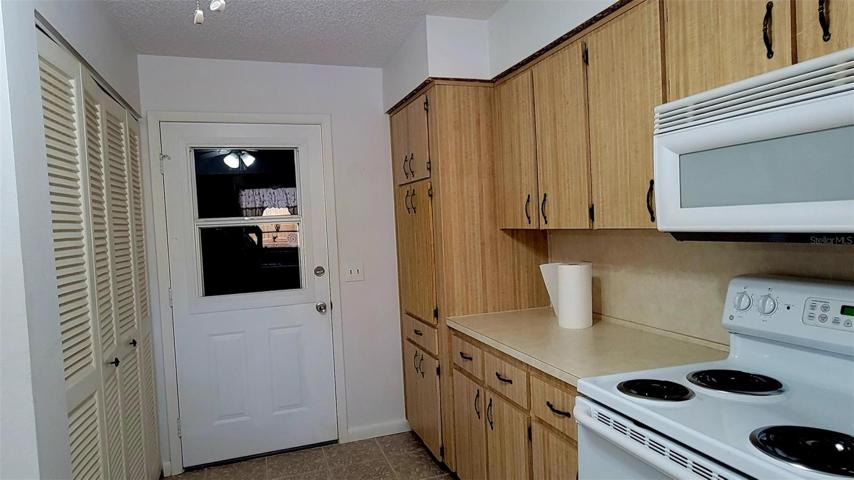 Kitchen w/Laundry closet & door to garage.