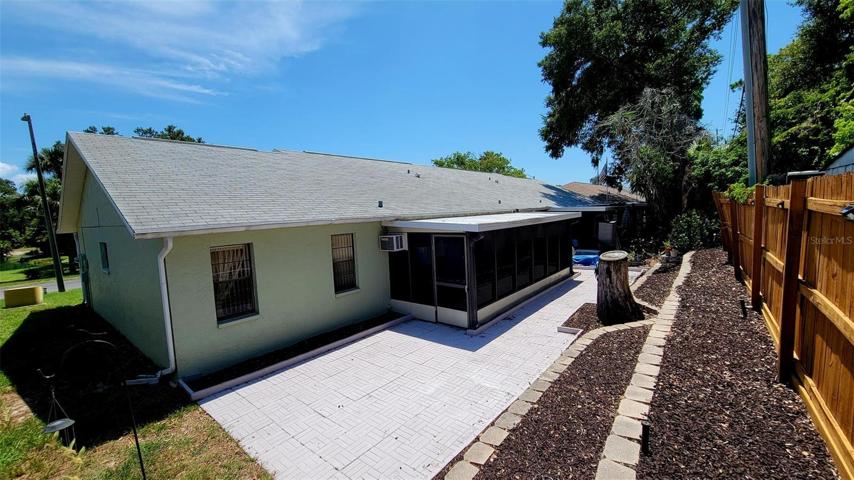 Back with patio & screened lanai w/soft vinyl windows. Faces north.