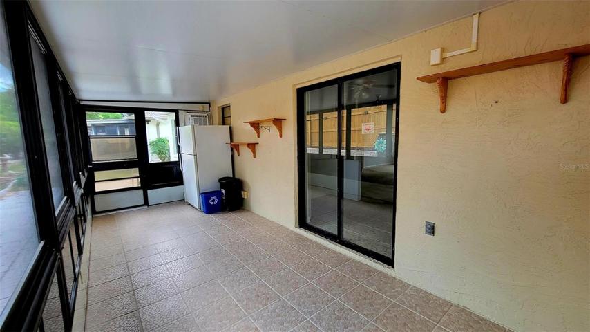 Lanai w/door to patio & slider to kitchen.