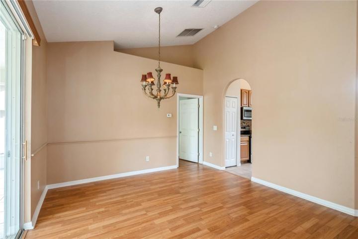 More dining room with kitchen entry. Other door is primary bedroom.