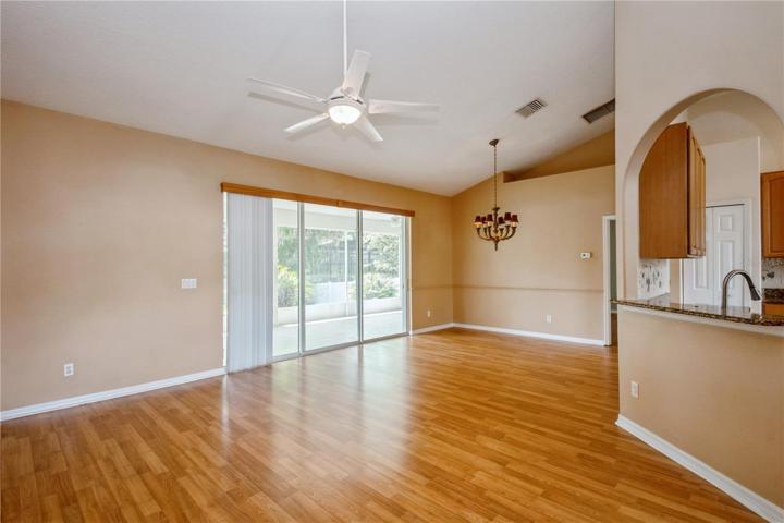 View of dining room and sliding doors to screened porch.