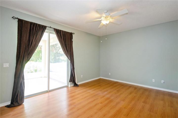 Owner's suite with sliding door to screened porch & lovely backyard