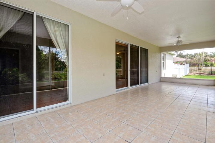Screen porch with ceiling fans. Two sliders into living area and primary bedroom