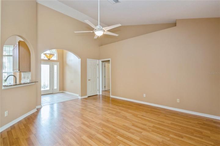Living room with view of foyer, kitchen and hallway to bedrooms