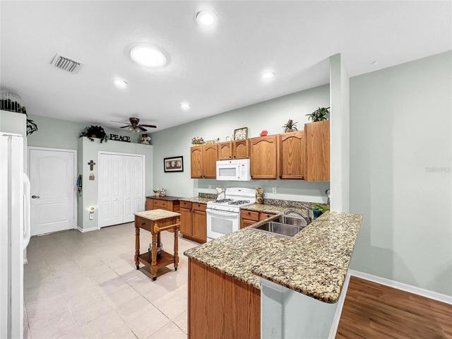 Folding doors hide large pantry; door into garage also has a storm door