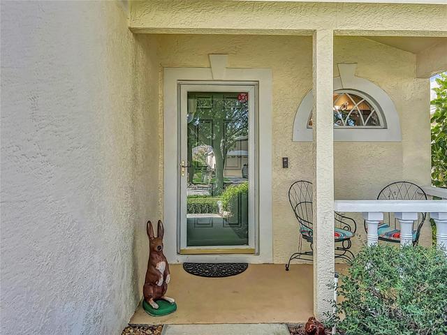 Welcoming green front door with storm door