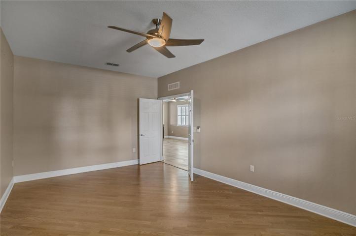 master bedroom with wood floors