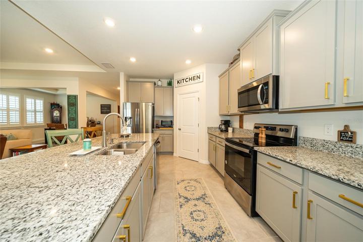 Attractive soft gray cabinetry with brushed brass hardware!