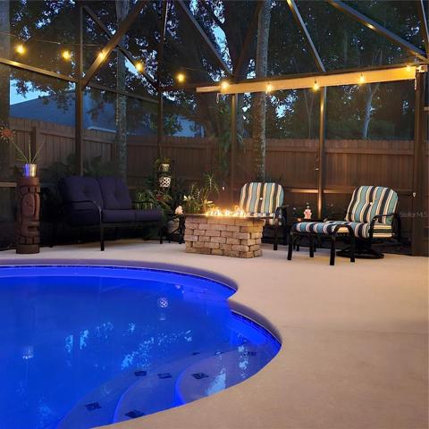 Firepit lit with pool light color blue
