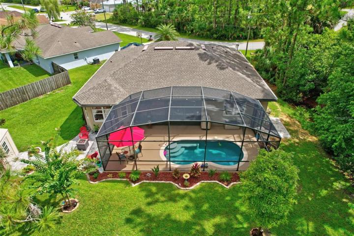 Drone view of home and pool area