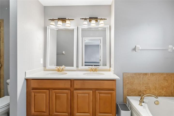 Double vanity in owner's bathroom is accented with custom lighting fixtures.