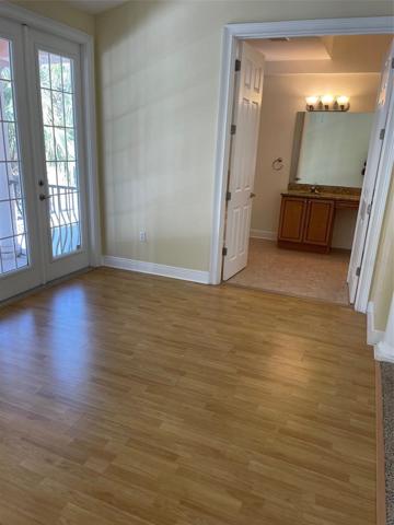 Looking through double doors to the Master bath, from the sitting area.