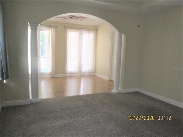 Master bedroom upstairs with French doors to a balcony. Bathroom is to the right past the archway.