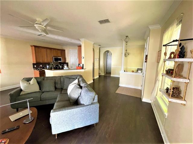 Living room looking towards the kitchen and dining area. Stairway to 2nd floor is on left just beyond kitchen.