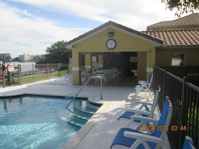Sun by the pool or relax in shady area with tables and chairs.