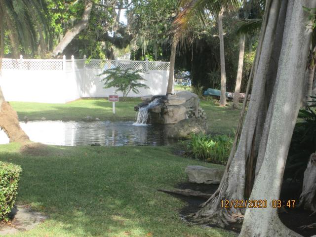 Picturesque pond w/ waterfall at the water front.