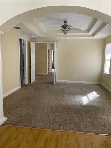 Master suite with coffered ceiling. Walk-in closet is 1st door on the left, double doors beyond lead to stairway on left & through open loft to 2 bedrooms and  hall bath.