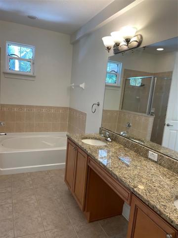 Granite countertop covers the vanity and has his & her sinks.