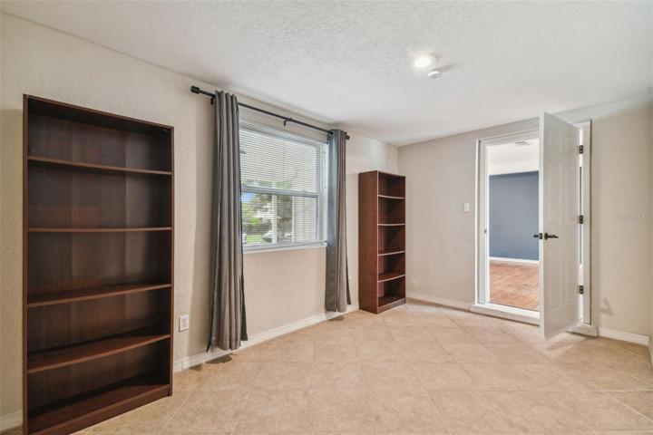 This bedroom offers a view of the street and front door