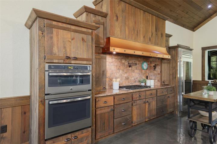 Wall oven and gas stove with wall-mounted pot filler.