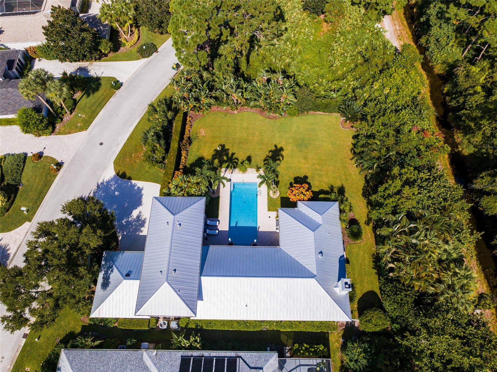 Aerial view of entire Home property showing tree bordering