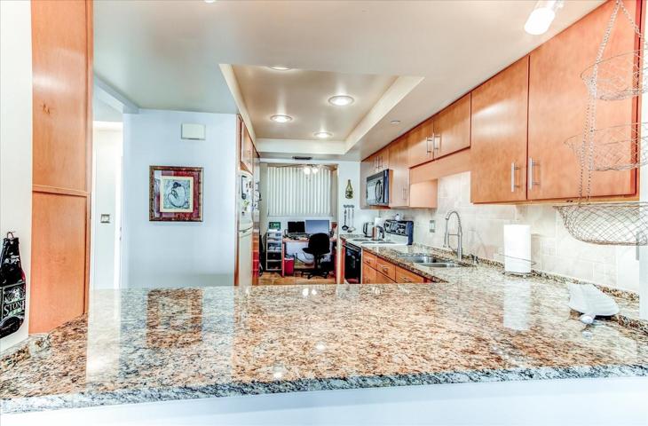 Recessed lighting with beautiful granite counters and upgraded cabinetry.