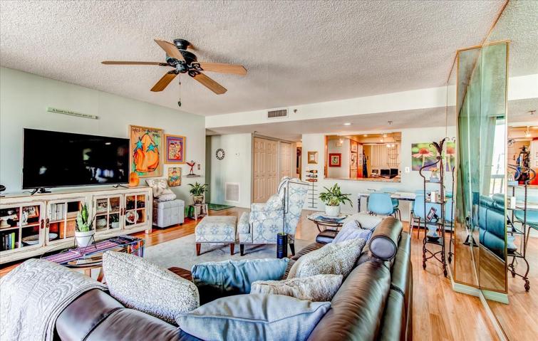 Living room view with open concept opening to dining and kitchen area.