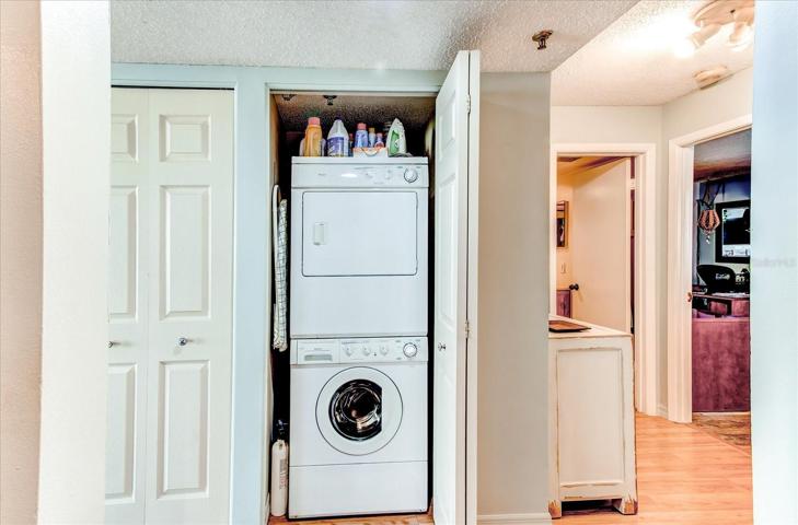 Hallway laundry with convenient stackable washer and dryer.