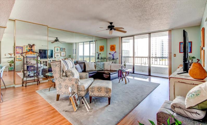 View of large living area facing balcony with lake view.