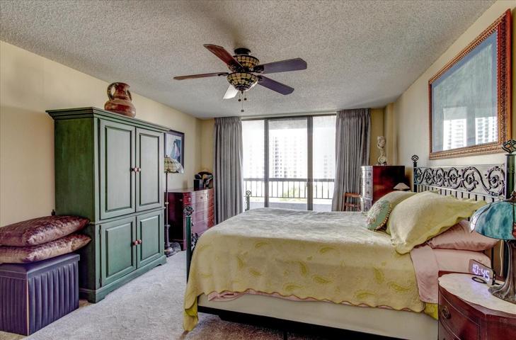 Spacious primary bedroom with balcony access.