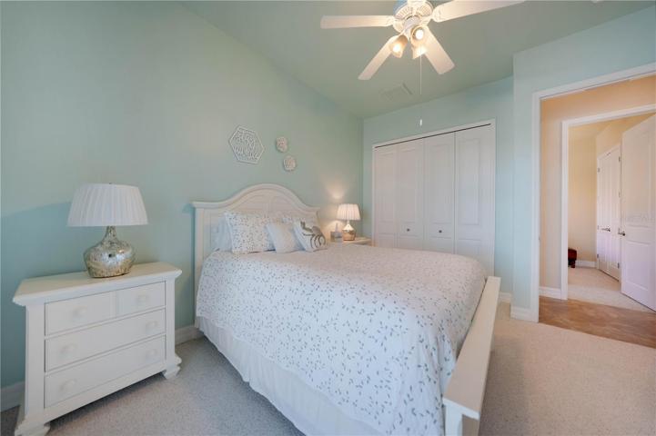 Main Guest Bedroom with sliders to lanai and pool