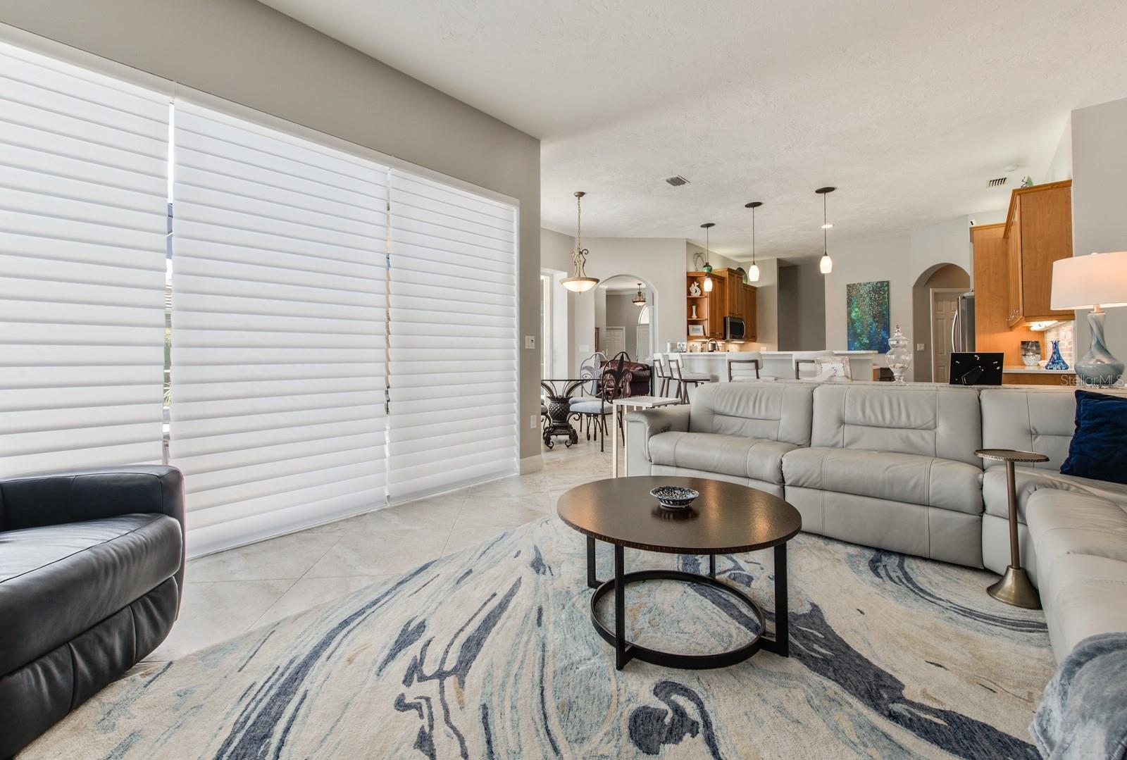 New designer blinds in the family room are operated by remote control for convenience and comfort.