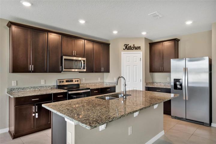 The home chef will appreciate the well equipped kitchen offering plenty of cabinet and counter space, large pantry for ample storage and an island with breakfast bar seating perfect for entertaining friends and family!