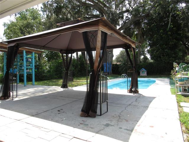 Cement pool deck with freestanding cabana.