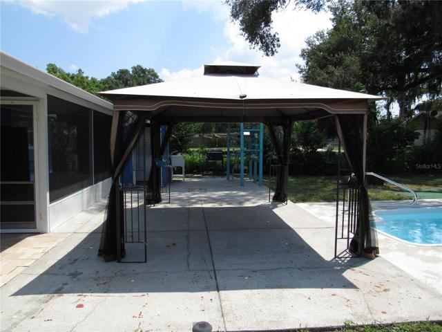 Cement pool deck with freestanding cabana.