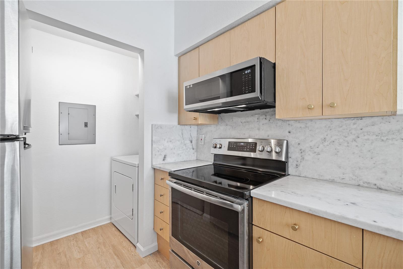 Oversized pantry with full-sized washer and dryer in unit