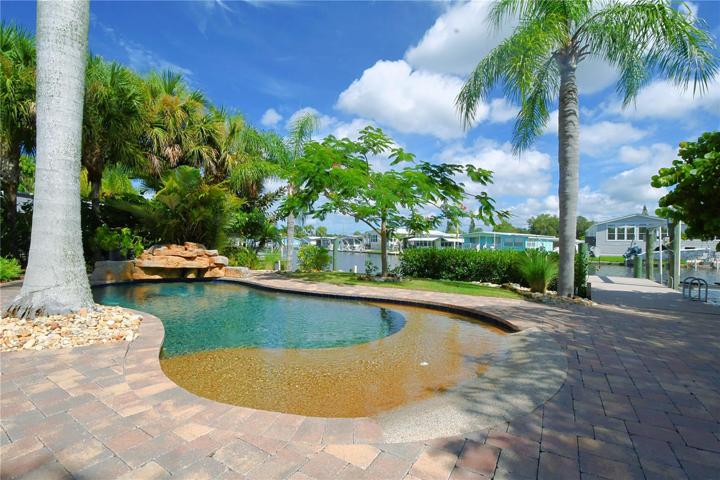 The pool is surrounded by a beautiful pavered deck.