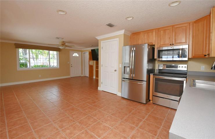 or the culinary enthusiast, ample storage can be found in the wooden cabinets and walk-in closet pantry.