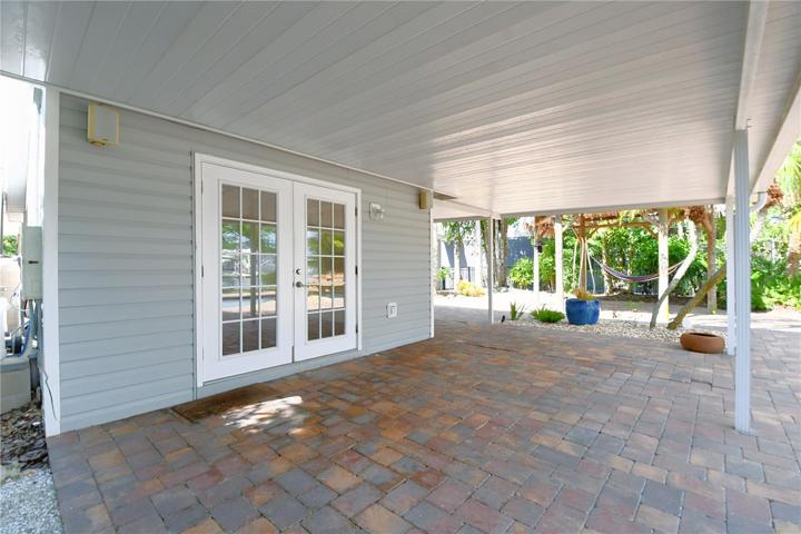 The pavered covered back patio is ideal for dining al fresco.