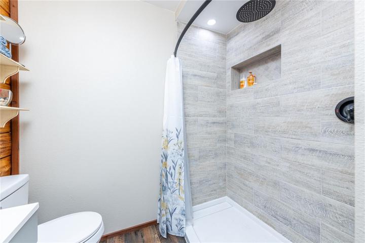 Master bathroom shower with shelf.